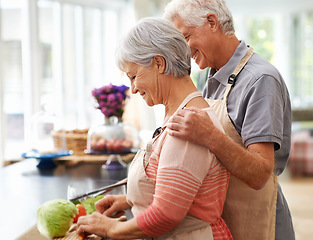 Image showing Cooking, health and love with old couple in kitchen for salad, help and nutrition. Happy, smile and retirement with senior man and woman cutting vegetables at home for food, dinner and recipe