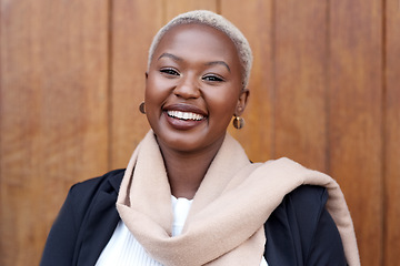 Image showing Face, fashion and portrait of a happy black woman with a smile, happiness and positive mindset. Headshot of female model person with beauty laughing against a wooden wall in city for business travel