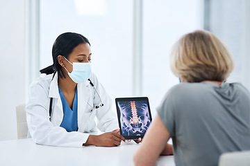 Image showing Doctor, patient and woman with tablet for spine, feedback or advice for injury, pain or safety with mask for covid. Medic, women and touchscreen for consulting, osteoporosis and explain with x ray