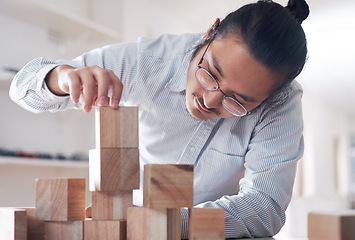 Image showing Building block, business and man with plan, vision challenge game and design innovation for balance at a startup. Engineering, architecture and designer with wood blocks for problem solving ideas.