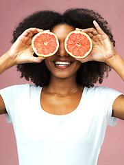 Image showing Grapefruit, smile and black woman cover her eyes in studio isolated on a pink background. Natural, fruit and African female model with vegan nutrition, vitamin c or healthy diet, detox or wellness