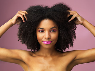 Image showing Face, hair care and black woman with afro in studio isolated on a pink background with eyeshadow. Hairstyle portrait, lipstick makeup and African female model with salon treatment for cosmetics.