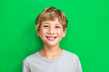 Image showing Portrait, green screen and boy with a smile, mockup and confident kid against a studio background. Face, male child and young person with happiness, relax and casual with development, happy and joy