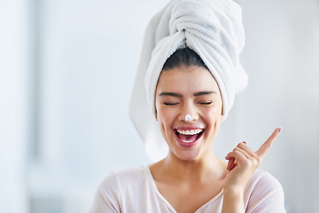 Image showing Happy woman, head towel and cream on nose for cosmetics, beauty and dermatology. Female person, face and laughing with facial lotion after shower for healthy shine, glow or aesthetic skincare at home