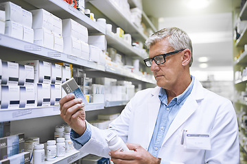 Image showing Pharmacy, medicine and search with man in store for label reading, inspection and inventory. Medical, healthcare and pills with mature male pharmacist in clinic for expert, wellness and product check