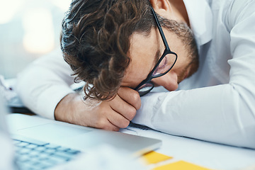 Image showing Overworked, tired and man sleeping on desk with burnout, fatigue and business employee with glasses, papers and laptop sleep in office. Businessman, lawyer and exhausted in company workplace