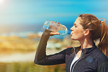 Image showing Woman drinking water, health and fitness in nature, blue sky and athlete outdoor with hydration and mockup space. Exercise at beach, female person drink h2o in bottle, workout and break from training