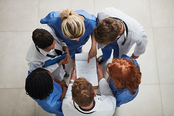 Image showing Above, doctor group and paperwork in a hospital and clinic with teamwork and collaboration. Medical team, nurse and healthcare workers with research paper and meeting in a circle with document