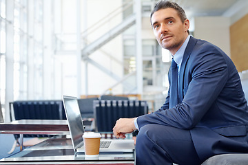 Image showing CEO or business man thinking in airport with laptop for invest strategy, stock market finance or financial review. Corporate professional waiting on sofa with tech doing research on economy