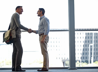 Image showing Mature business people, handshake or partnership deal in airport lounge, hotel lobby or modern office for financial crm. Smile, happy or corporate men shaking hands in welcome, thank you or greeting