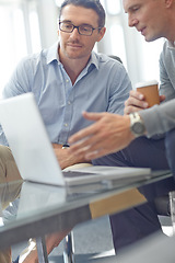 Image showing Elderly businessman, laptop and discussion for digital marketing, deal or corporate proposal idea at the office. Business people talking, strategy or planning advertising in conversation at workplace