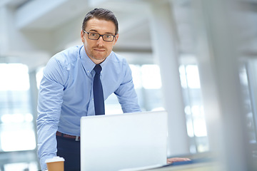 Image showing Portrait, laptop and mission with a businessman working on research in his office for a report. Computer, mindset and vision with a male employee working on innovation or planning for success