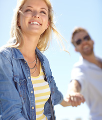 Image showing Love, holding hands and couple walking, happy and enjoy outdoor quality time together, bond and fun romantic date. Freedom, peace and happiness for man and woman on summer holiday in Lisbon Portugal