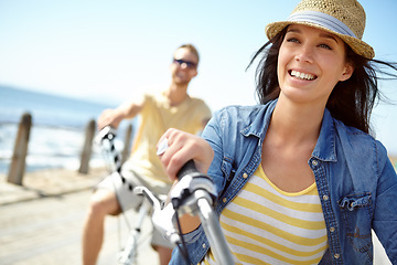 Image showing Bike, cycling and couple with a travel woman on summer vacation or holiday riding on the promenade by the beach. Freedom, date and romance with a girlfriend outdoor for a ride on the coast