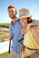 Image showing Happy couple, mini golf and hug on summer date, fun activity and freedom in sunshine. Man, woman and young people playing outdoor games with love, happiness and quality time together on sunny day