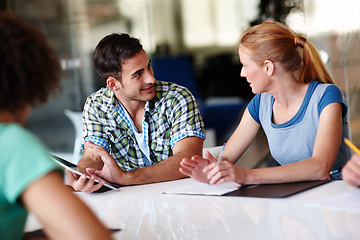 Image showing Startup business, talking and employees brainstorming, conversation or share ideas at the workplace. Coworkers, staff or group with discussion, planning or teamwork for development and growth