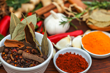 Image showing Food, leaf and spices on table top for cooking meal, turmeric seasoning or paprika flavor. Vegetables, kitchen condiments and variety of plant herbs in bowls for brunch, healthy diet or vitamins.