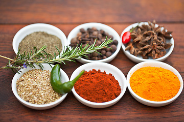 Image showing Food, turmeric and spices on table top for cooking gourmet meal, pepper seasoning or paprika flavor. Vegetables leaf, kitchen condiments and variety of plant herbs in bowls for brunch or healthy diet