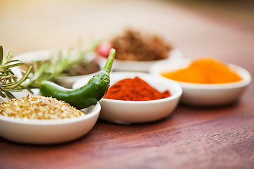 Image showing Food, pepper and spices on table for cooking gourmet meal, turmeric seasoning or paprika flavor. Chili vegetables, kitchen condiments and plant herbs in bowls for brunch, healthy diet and vitamins.