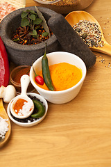 Image showing Table top, mortar and food spices for cooking gourmet meal, turmeric seasoning or flavor pestle. Pepper vegetables, kitchen condiments and variety of plant herbs for brunch, healthy diet or vitamins.