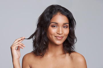 Image showing Portrait, beauty and hair with a woman in studio on a gray background for natural hair treatment. Face, skin care and shampoo with a young Indian female model at the salon for a haircut or cosmetics