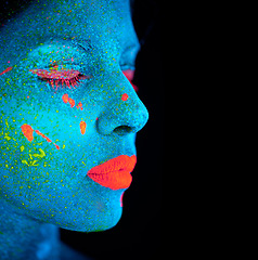 Image showing Neon paint, makeup and woman face with beauty closeup in dark background and creative cosmetics. Glow, fantasy and psychedelic cosmetic of female model with unique and creativity with art in studio