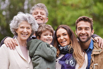 Image showing Big family, happy and grandparents or parents with kid in a park on outdoor vacation, holiday with faces together. Mother, happiness and father smile with child for love, care and bonding in nature