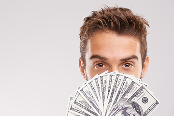 Image showing Man, portrait and money fan in front of face with cash, dollars and financial success isolated on studio background. Economic stability, finance and bonus with reward, wealthy male and mockup space