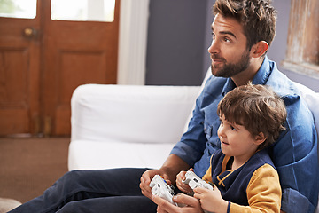 Image showing Video games, father and son on a sofa, entertainment and relax at home, kid and fun in the lounge. Family, dad or boy with parent, male child and controller on a couch, happiness or multiplayer app