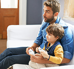 Image showing Online game, father and son on a couch, bonding and relax at home, cheerful and happiness. Family, dad and boy with parent, happy male child and kid with controller, entertainment and multiplayer app