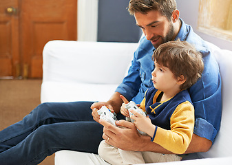 Image showing Gaming, dad and son on a sofa, playful and bonding with fun, happiness and chilling at home. Family, father and boy with parent, male child and kid with controller, video games and multi player app