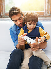 Image showing Gaming, father and son on a sofa, video game and loving at home, quality time and relax in the lounge. Family, happy dad and boy with parent, male child and gamer playing online, cyber and carefree