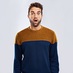 Image showing Shock, portrait and male model in a studio with an amazed or surprise facial expression or attitude. Shocked, amazing news and man with a wtf, omg or wow face emoji isolated by a white background.