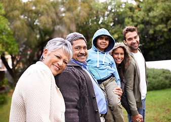 Image showing Big family, portrait and generations in park with kid, parents or grandparents for love, care and happiness. Group, senior people and child for bond, walking and support by trees, nature or holiday