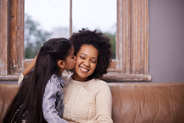 Image showing Kiss, mother and girl with a smile, home and loving with joy, relationship and happiness. Family, parents and mama with kid, female child and kissing in the living room, care and bonding on a couch