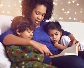 Image showing Children, mother and reading a book in a family home for story time on lounge sofa with bokeh. A woman or mom with kids together for development, learning and love with a fantasy, magic or fairytale