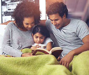 Image showing Child, father and mother reading book in a family home for story time on a lounge sofa with a smile. A woman, man and girl child together for development, learning and love for a fantasy or fairytale