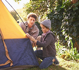 Image showing Dad, child and tent for camping outdoor in nature on vacation while bonding in summer sunset. Father, boy and setting up camp, learning and getting ready in forest for adventure, holiday or travel.