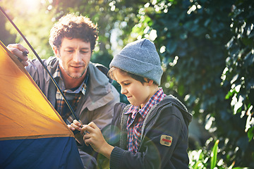 Image showing Father, child and set up tent for camping outdoor in nature on vacation while bonding in summer. Dad, boy and preparing campsite, learning and getting ready in forest for travel, education or holiday
