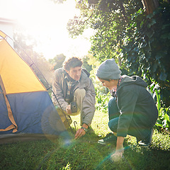 Image showing Father, child and hammer tent for camping outdoor in nature on vacation, bonding together and sunset. Dad, boy and preparing camp, learning and helping in forest for travel, holiday and adventure.