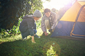 Image showing Father, kid and hammer tent for camping outdoor in nature on vacation, bonding together and sunset. Dad, boy and preparing camp, learning and helping in forest for travel, education and adventure.