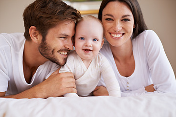 Image showing Portrait, happy family and parents with baby on bed for love, care and quality time together at home. Mother, father and newborn child relaxing in bedroom for development, caring support or happiness