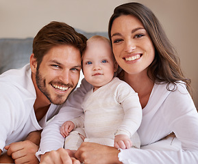 Image showing Portrait, happy family and parents with baby for love, care and quality time to relax together in house. Mother, father and smile with cute infant kid for happiness, support and newborn development