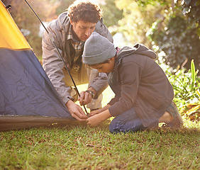 Image showing Dad, child and preparing tent for camping outdoor in nature on vacation while bonding in summer sunset. Father, boy and setting up camp, learning and getting ready in forest for adventure or travel.