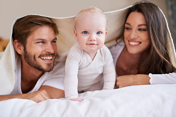 Image showing Portrait of baby, happy mother and father with blanket in bedroom for love, care and quality time together. Fun parents, playful newborn child and family relaxing with bedding fort, smile and at home