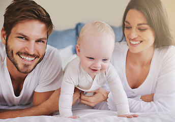 Image showing Happy family, baby and parents on bed for love, care and quality time together at home. Mom, dad and cute newborn child relaxing in bedroom for happiness, support and smile for development of kids