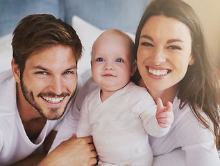 Image showing Portrait of happy family, baby and parents with love, care and quality time together at home. Mom, dad and cute newborn kid relaxing with smile, happiness and support of healthy childhood development