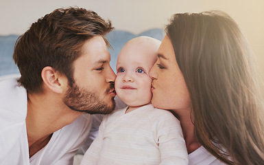 Image showing Happy father, mother and kiss baby on cheek for love, care and quality time to relax together in family home. Mom, dad and kissing cute newborn kid for happiness, loving support or infant development