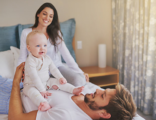 Image showing Happy mother, father and fun with baby in bedroom for love, care and quality time to relax together at home. Mom, dad and parents playing with infant kid for happiness, support or newborn development