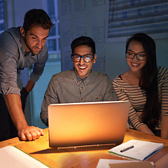 Image showing Collaboration, night and a business team on a laptop, working in the boardroom for planning, strategy or innovation. Meeting, teamwork and overtime with a group of employees at work in the evening